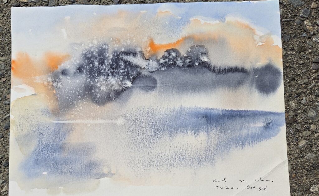 A watercolour painting of a misty lake at dawn in soft blues and oranges.